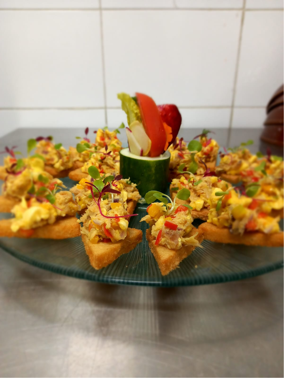 Savory canapé bites arranged on crisp toast rounds with microgreens.