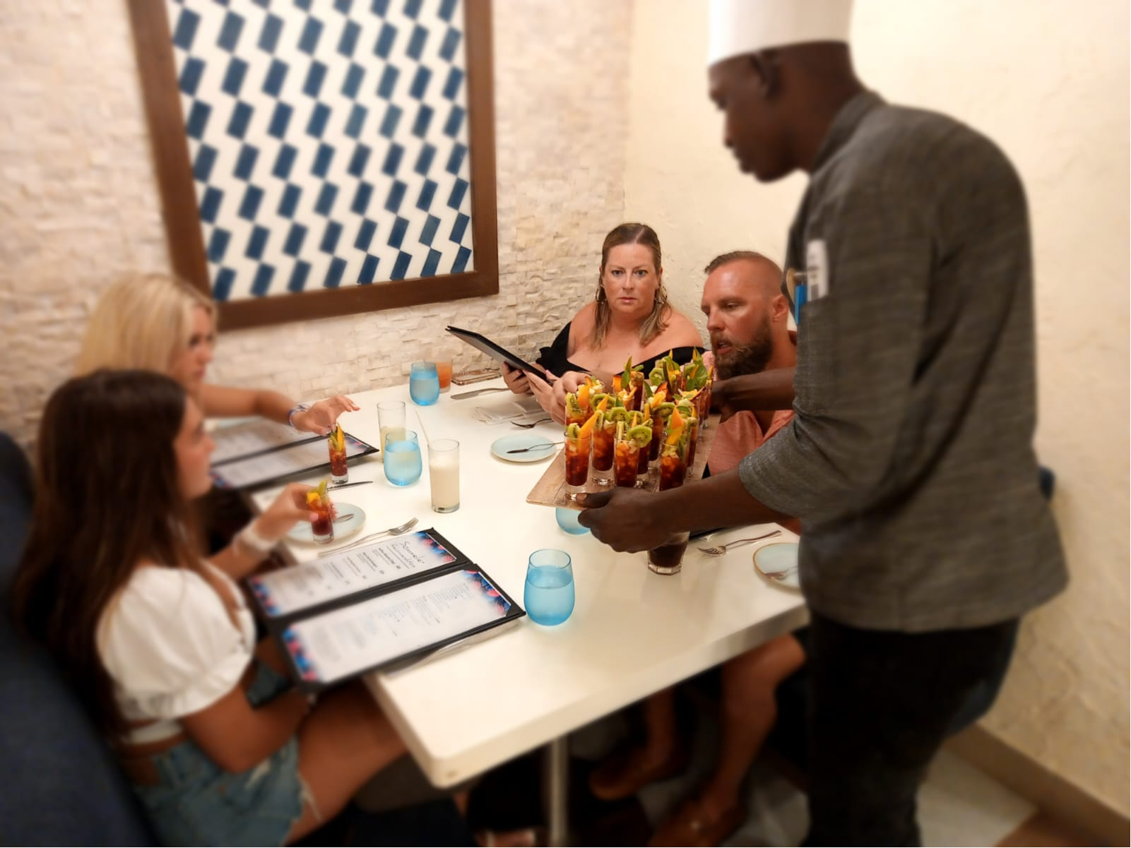 Chef Dejon serving cocktails tableside.