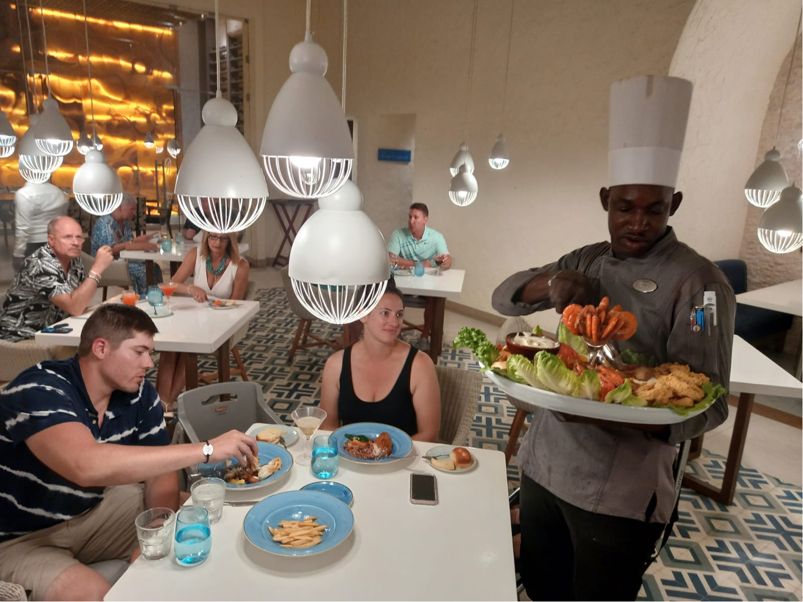 Chef Dejon presenting a seafood platter.